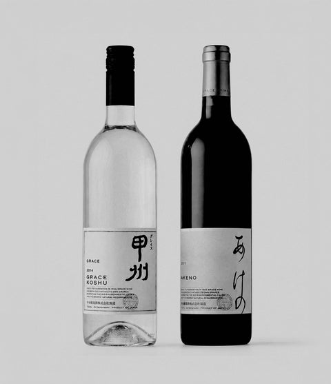 Two wine bottles from Grace Wine with labels featuring Japanese text on a light gray background