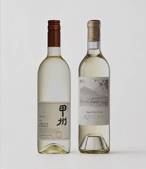 Two bottles of Koshu white wine with labels on a light gray background